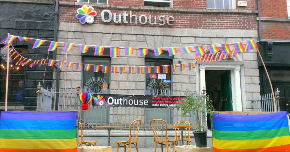 exterior of Outhouse decorated in pride flags