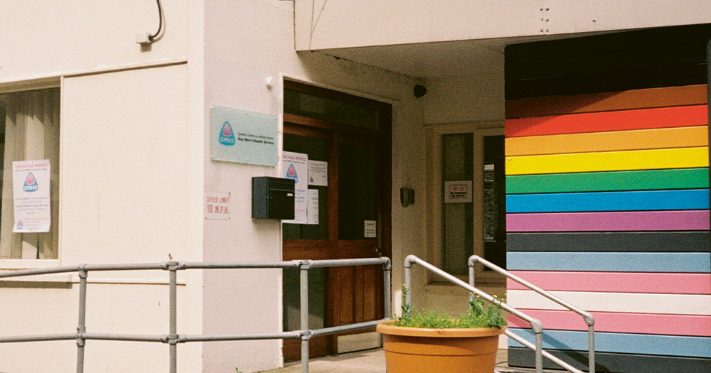 The exterior of a building with one multicoloured wall