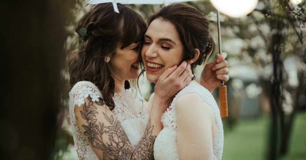 Sophie and Claire get close in their wedding dresses for their nuptials at the Millhouse