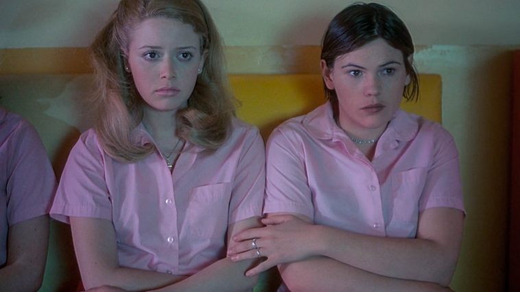 two girls sitting next to each other