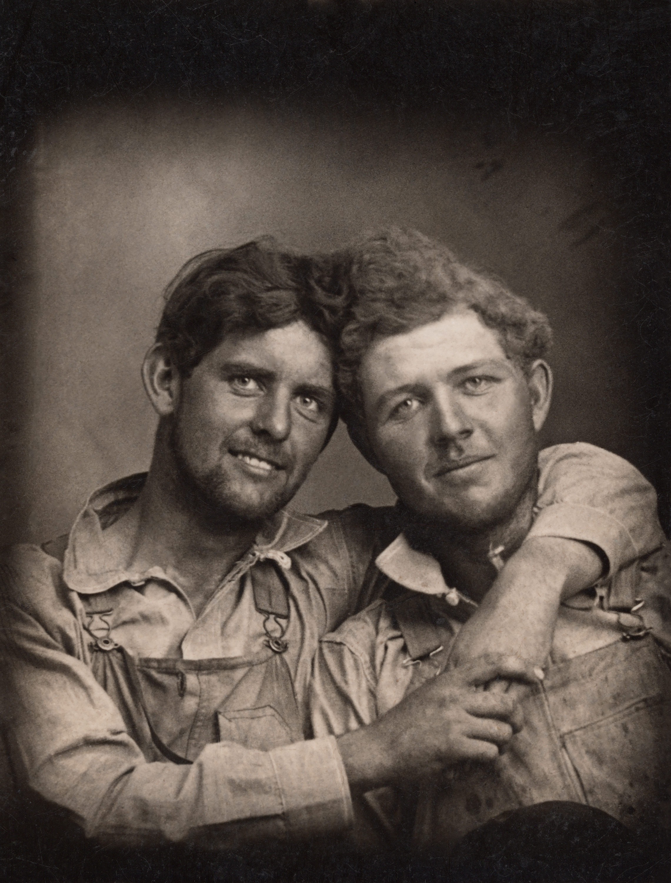 two men in overalls with their arms around each other, Loving a history of men in love through photographs