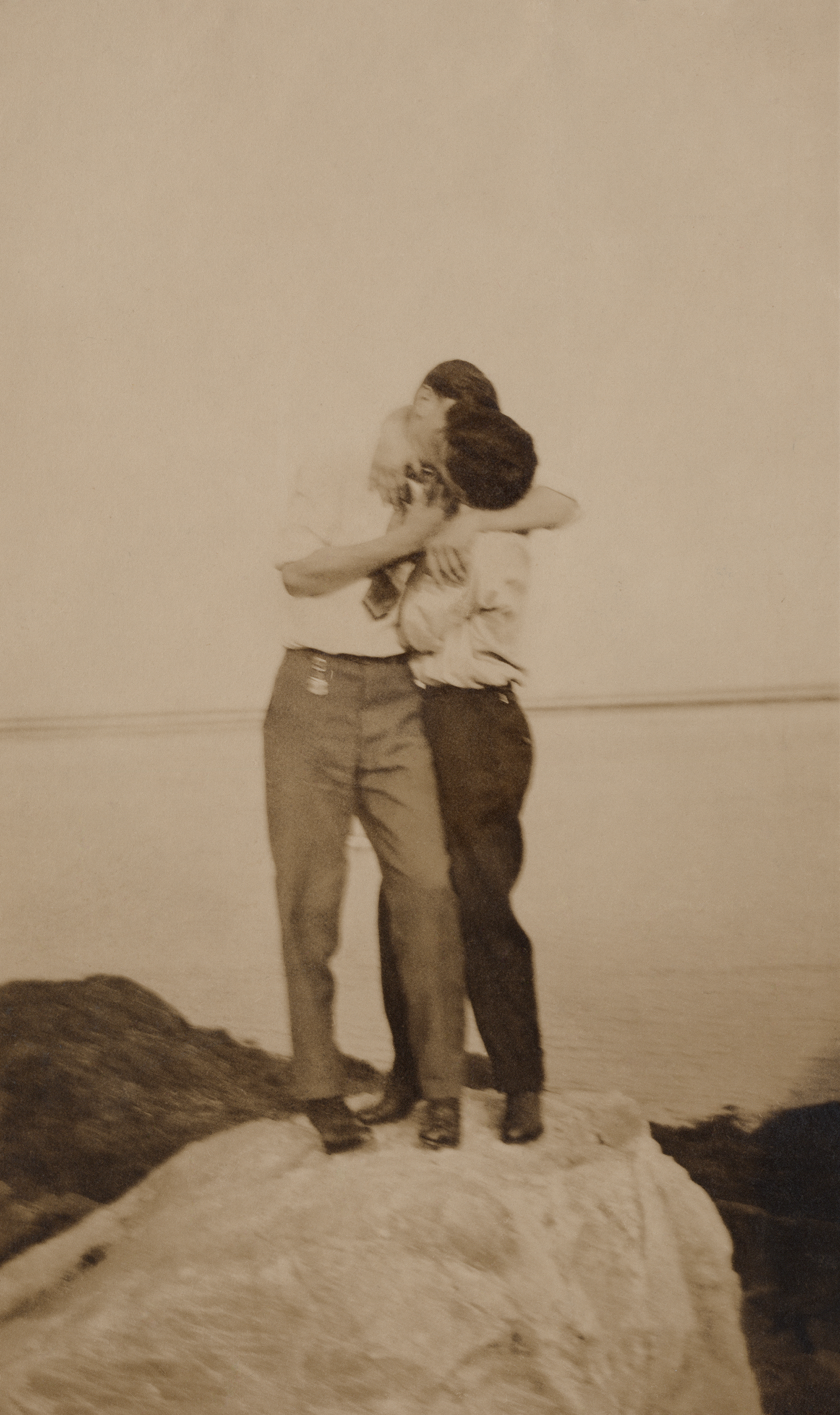 Two men kissing on top of a rock, Loving, a history of men in love through photographs