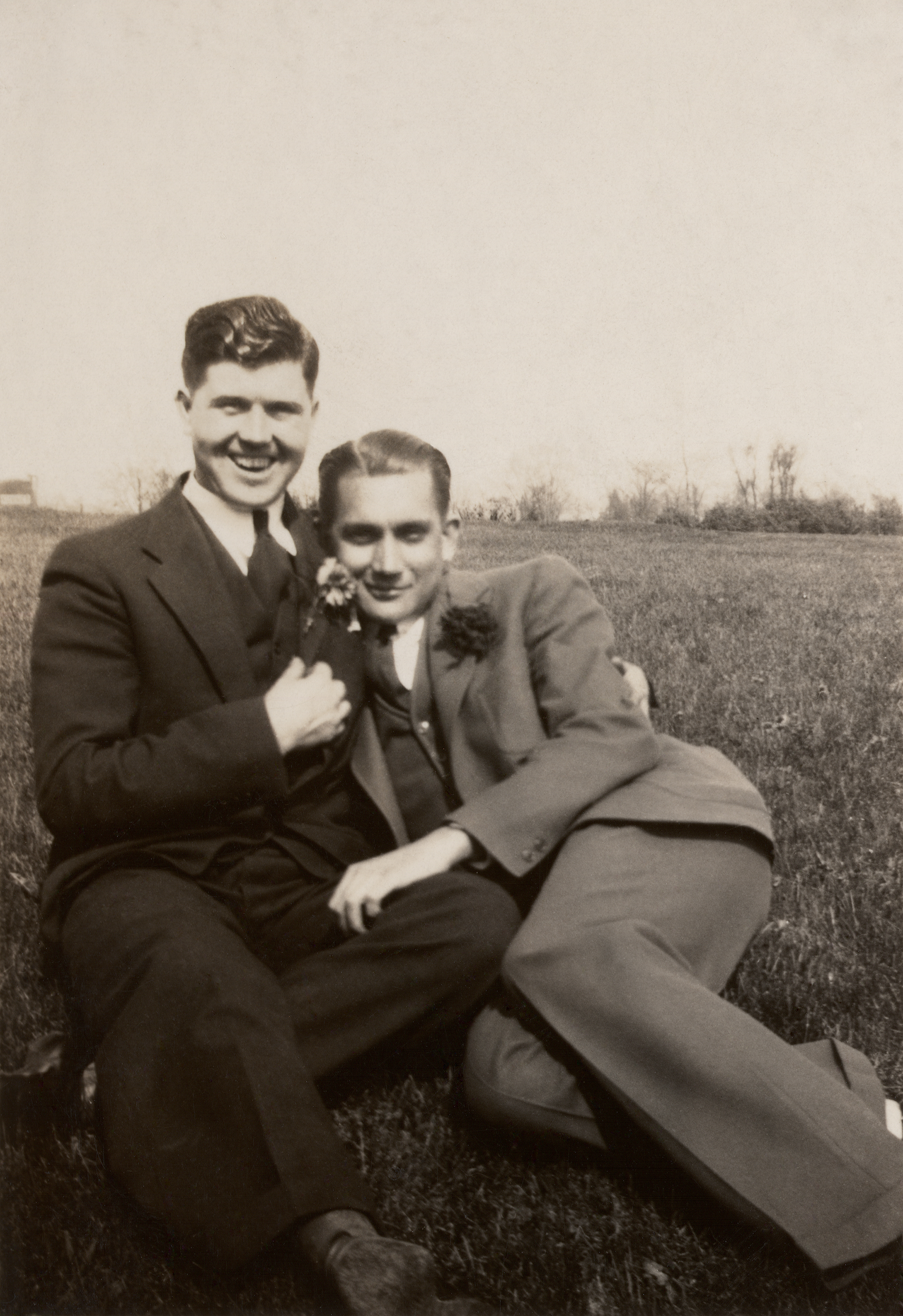 two men in suits with their arms around each other