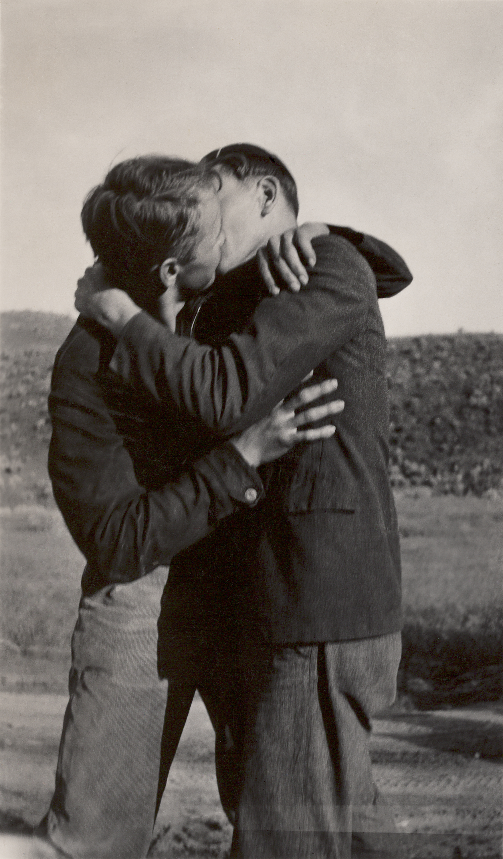 Two men kissing in a field, Loving, a history of men in love through photographs
