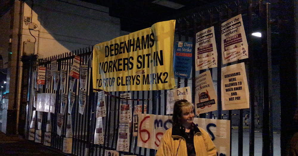 Signs on a fence in support of Debenhams workers