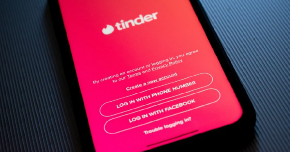 dating transphobia a phone screen displaying the app Tinder