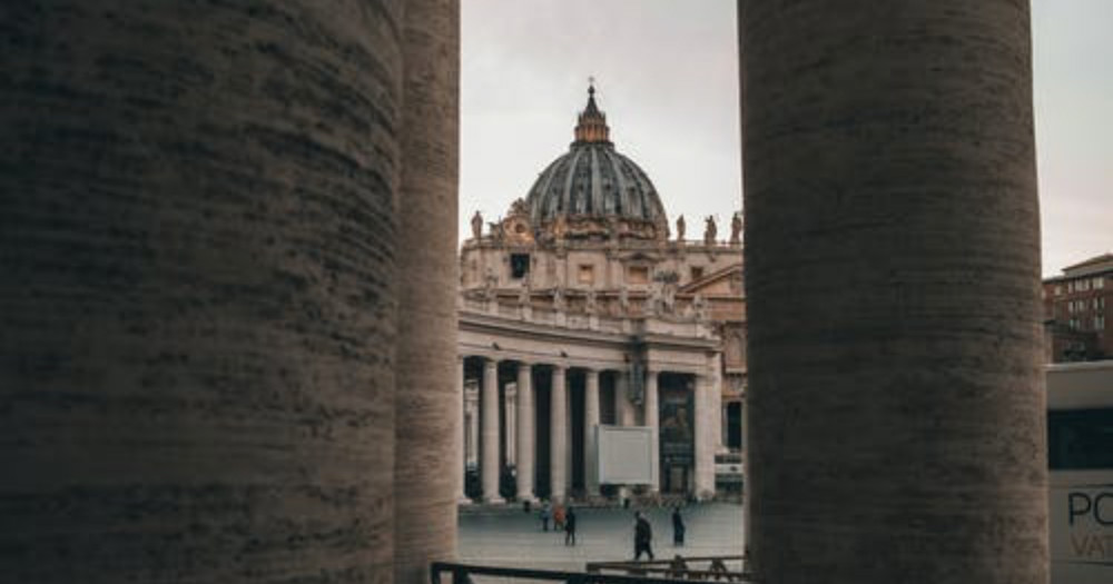 The Vatican framed between two pillars, the Vatican back tracks the Pope's remarks.
