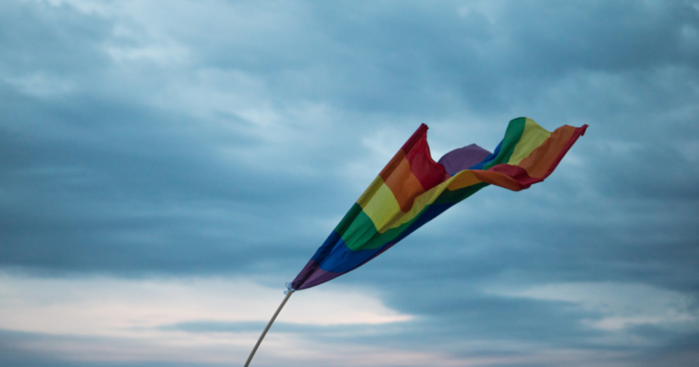 pride flag flying in the wind, words the LGBTQ+ community has reclaimed