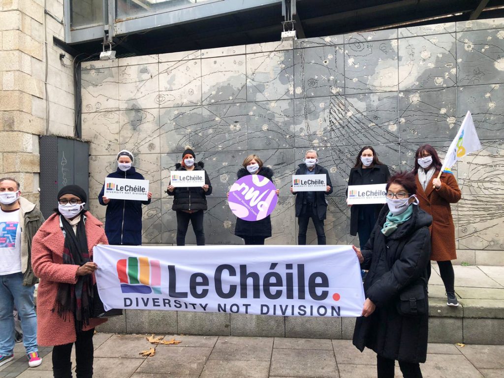 Members of Le Chéile alliance holding a banner that reads "diversity not division"