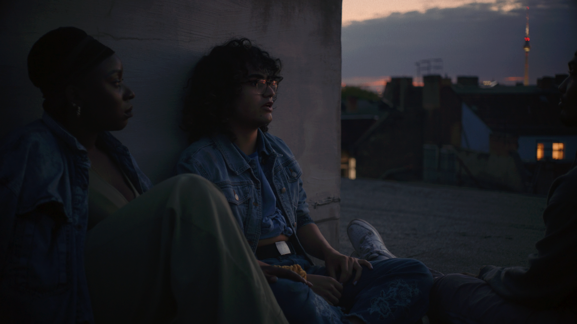 two ballroom dancers sat beside eachother whilst the sun is setting on Berlin for documentary