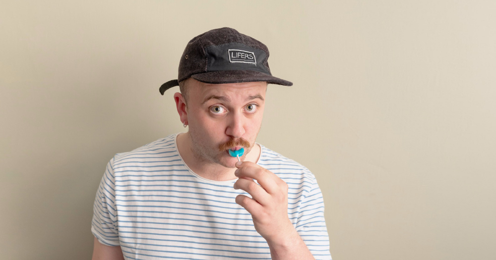 Lockdown LOLZ: Image of host Shane Daniel Byrne sucking a lollypop