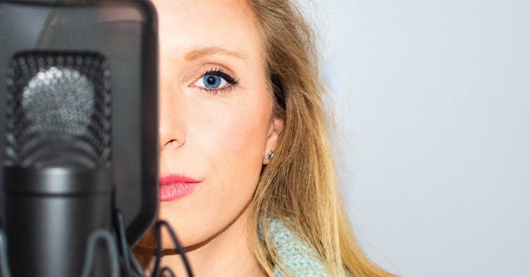 A woman standing behind a microphone