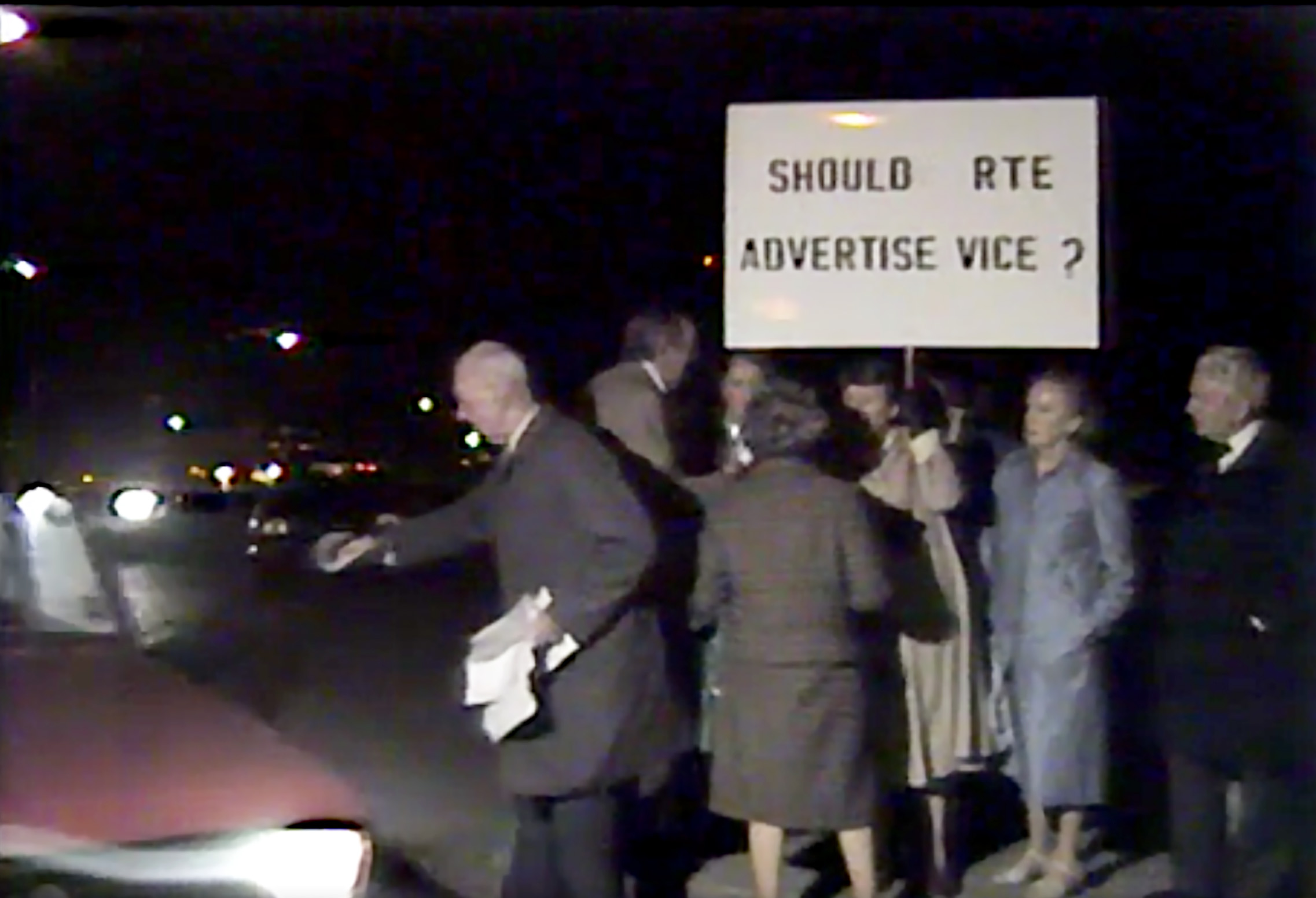 A group of people protesting at night