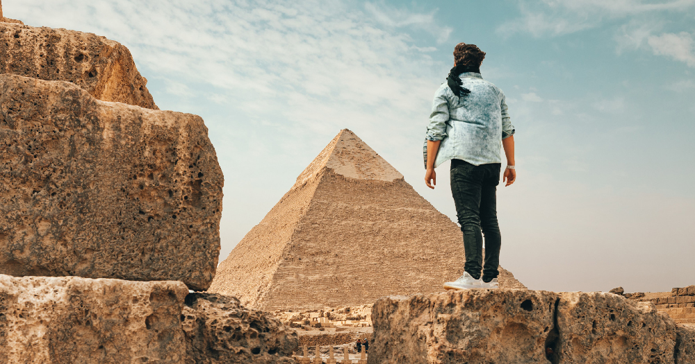 A man in front of the pyramids in Egypt