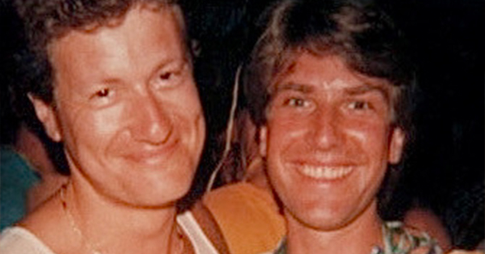 A photo of two smiling men from the 1980s
