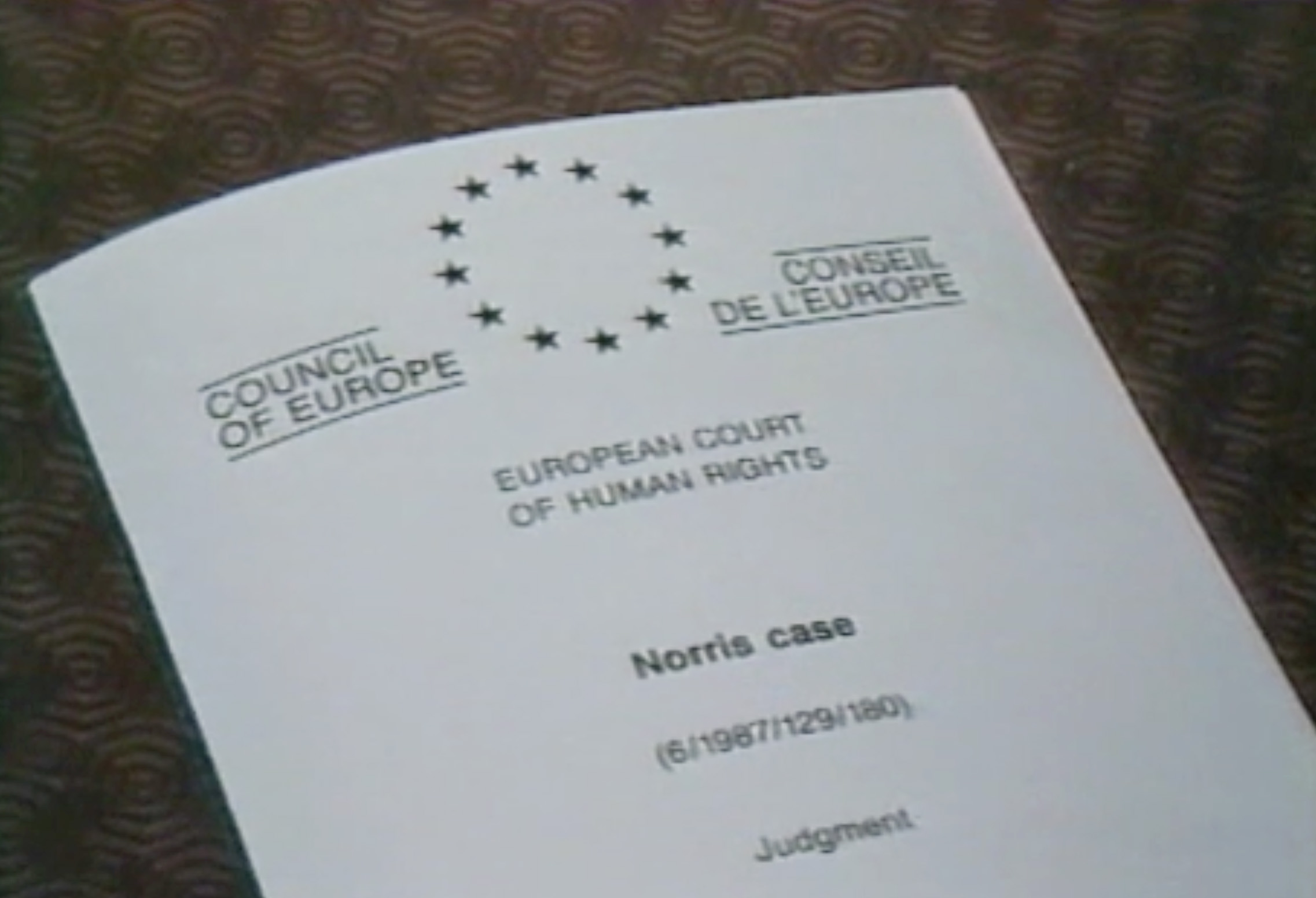 A document from the European Court of Human Rights lays on a table
