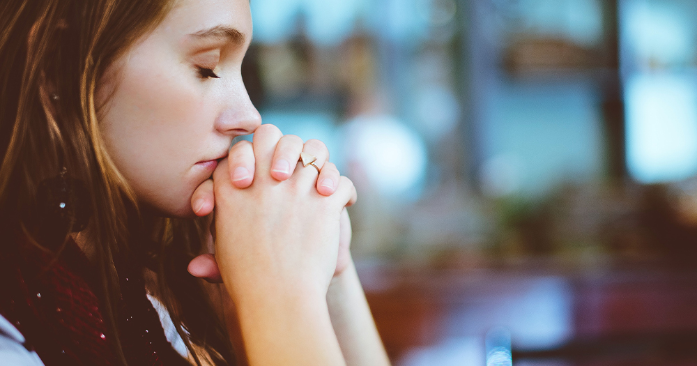 A young woman praying