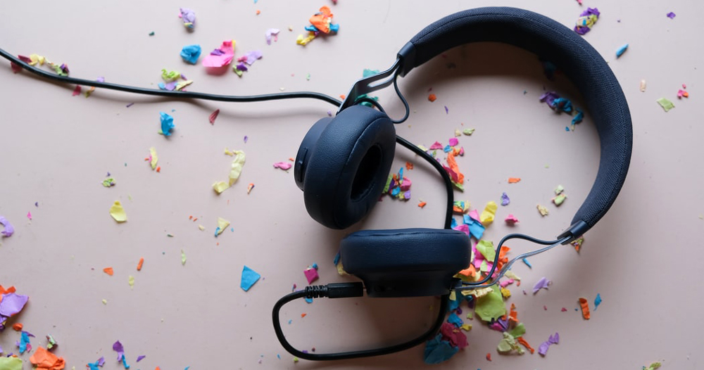 Headphones surrounded by multicoloured confetti