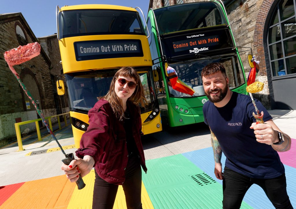 Dublin Bus & GCN launch: a woman and a man pose a top a rainbow crossing