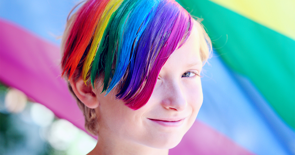 A young person with rainbow dye in their hair