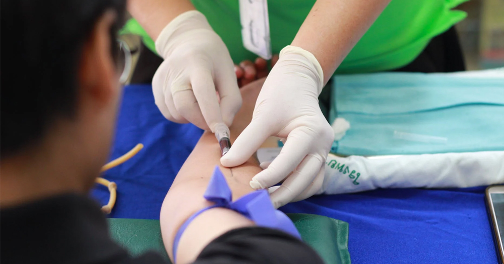 a close up image of gloved hands inserting a needle in the arm of a man donating blood. A new campaign has launched calling for the end to blood donor ban in Ireland
