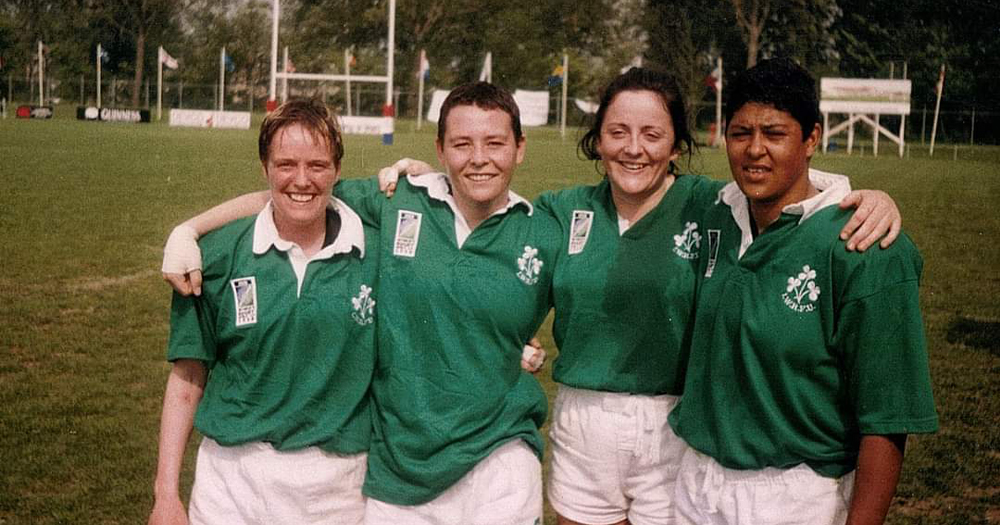 Four women in rugby gear embrace after a match