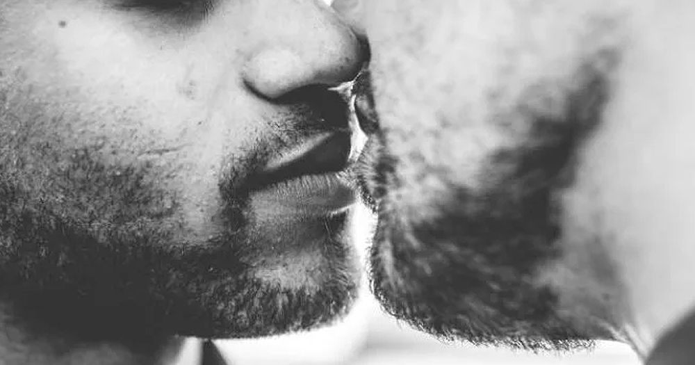 A black and white close-up of two bearded men kissing. In this story, we talk about sex during lockdown for queer Irish people