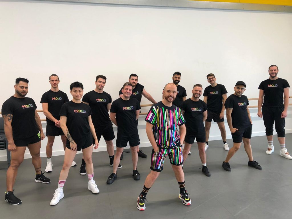 A group of dancers pose featured in Conleth Kane's Proud Remix video pose.