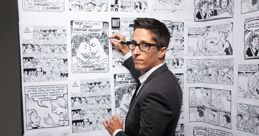 A woman with short hair in a suit draws comic strips on a wall. Promotional image ahead of GAZE Film Festival return to cinemas.