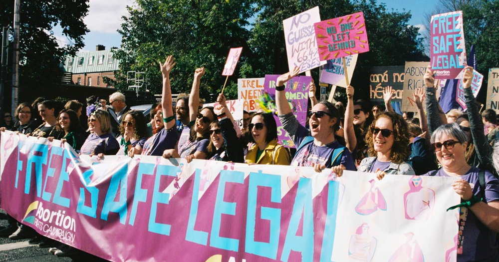 Women marching behind a banner that reads 'free safe lega'. The 10th Annual March Choice will take place on September 20.