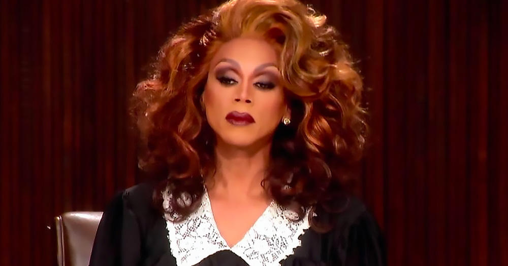 A drag queen dressed as a judge sitting in court