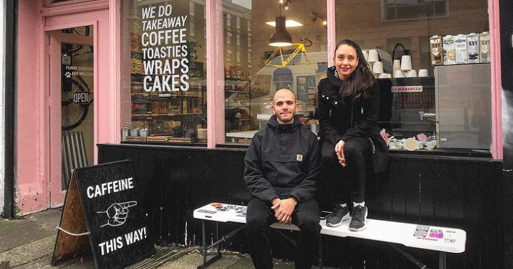 Owners of It's a Trap sit outside their vegan coffee shop.