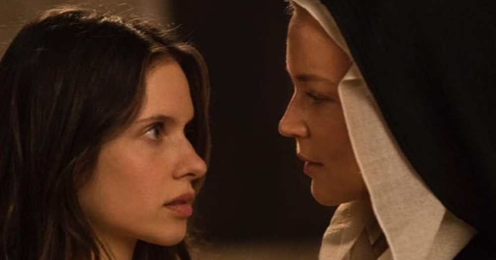 A screen grab from the film Benedetta which shows two nuns looking deep into each other's eyes.