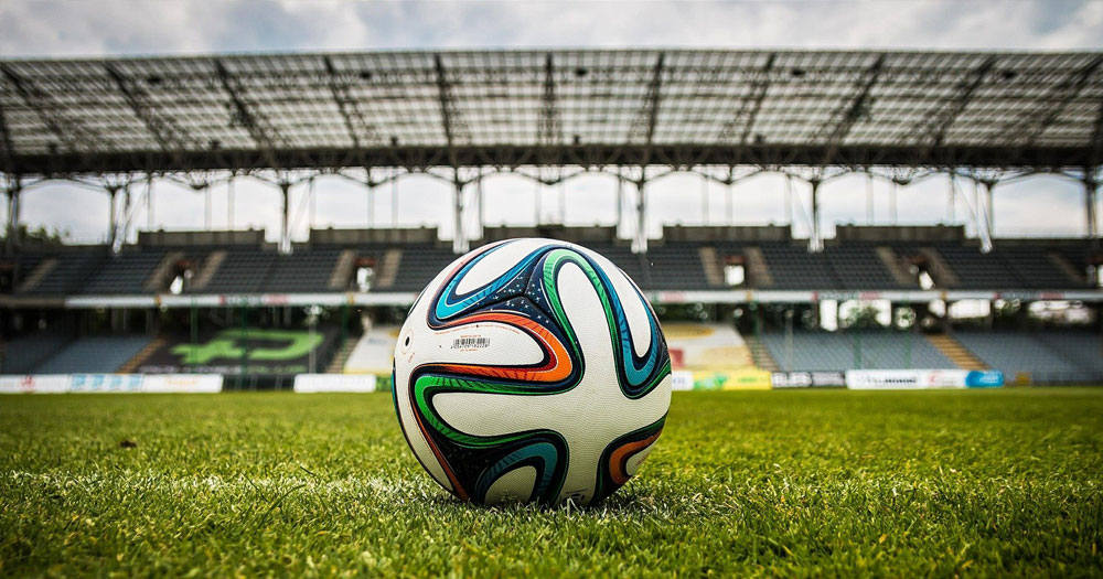 Close up of soccer ball on the field of an empty stadium