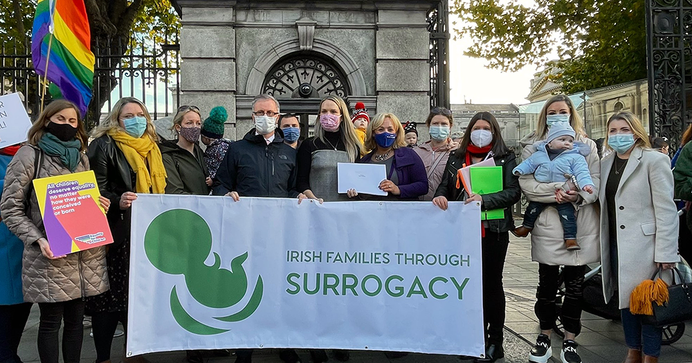Irish Families Through Surrogacy hold a banner alongside Roderick O'Gorman and representatives from LGBTQ+ groups as they met to discuss Irish surrogacy legislation outside the Dáil.
