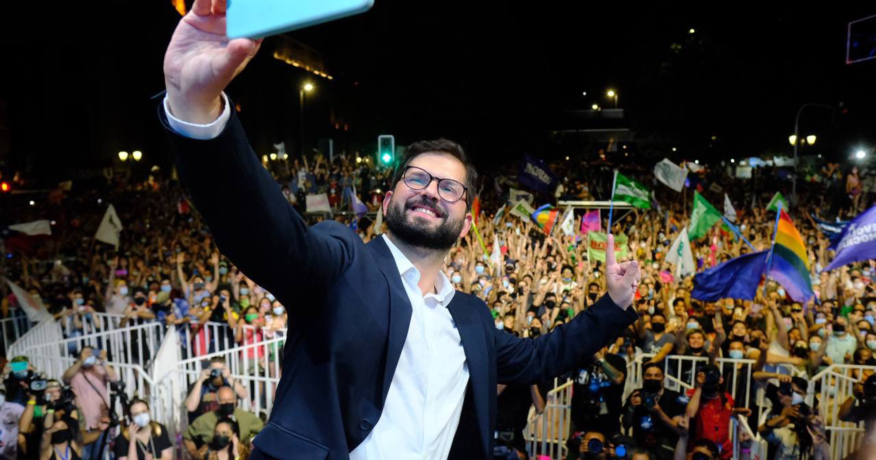Gabriel Boric takes a selfie with a crowd of supporters after being elected president of Chile.