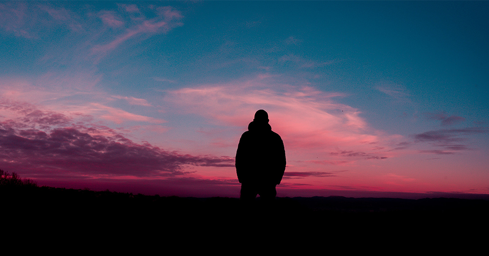 A man in silhouette against a sunset