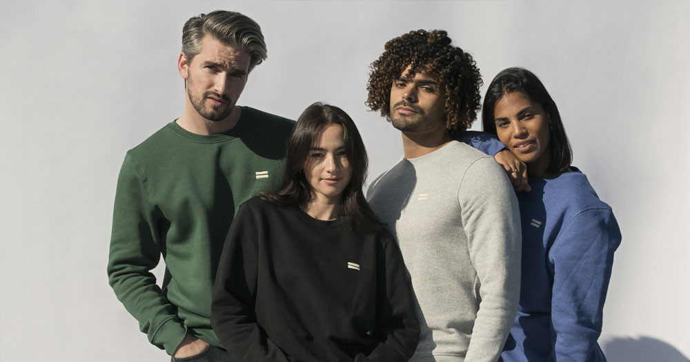 Four people modelling the Human Collective fashion line
