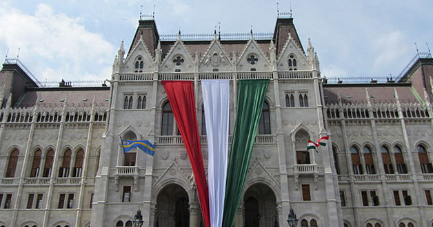 A photo of the Hungarian parliament building decorated with the Hungary flag where an anti-LGBTQ+ referendum was approved.