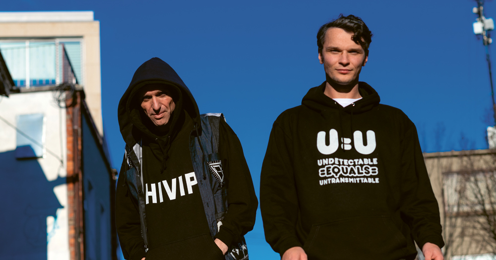 Image of Poz Vibe podcast Veda and Robbie in colourful jacket emblazoned with the text U=U