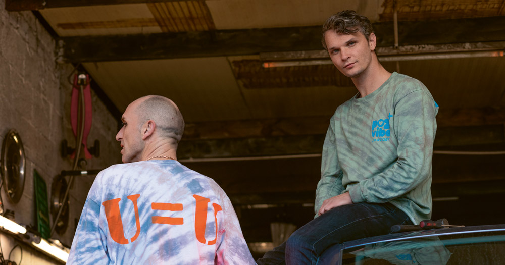 Image of Poz Vibe podcast Veda and Robbie in colourful jacket emblazoned with the text U=U
