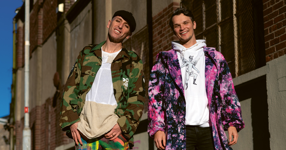 Image of Poz Vibe podcast Veda and Robbie in colourful jackets