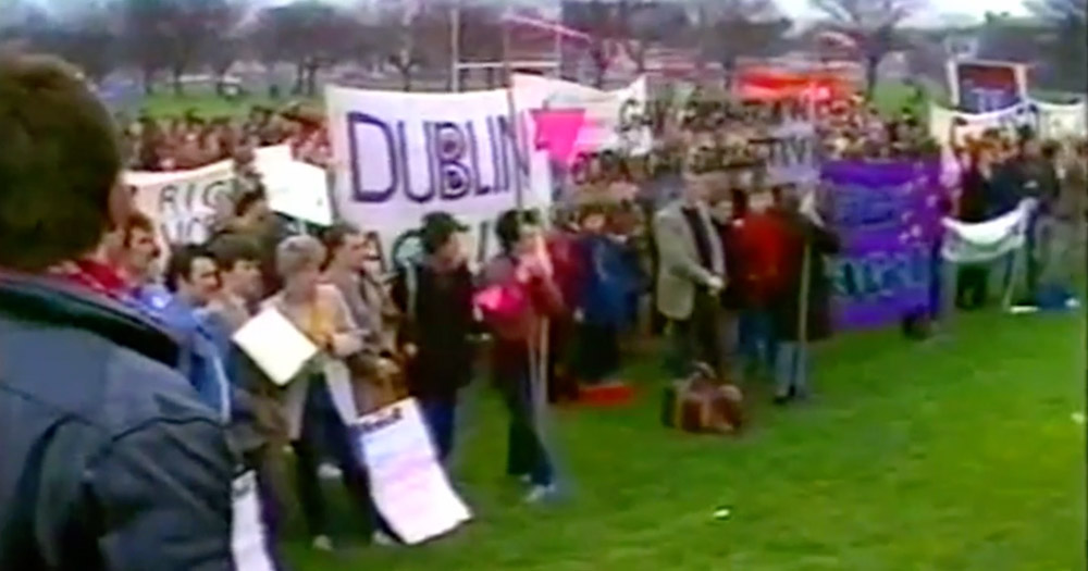 Video still of demonstrators gathered in Fairview Park in 1983 to protest over LGBTQ+ and women's rights.