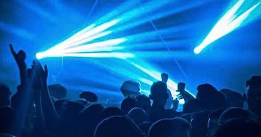 Mother is hiring a Digital Market and Communications person. The photograph shows a dance club with blue light beams cast above the heads of dancers.