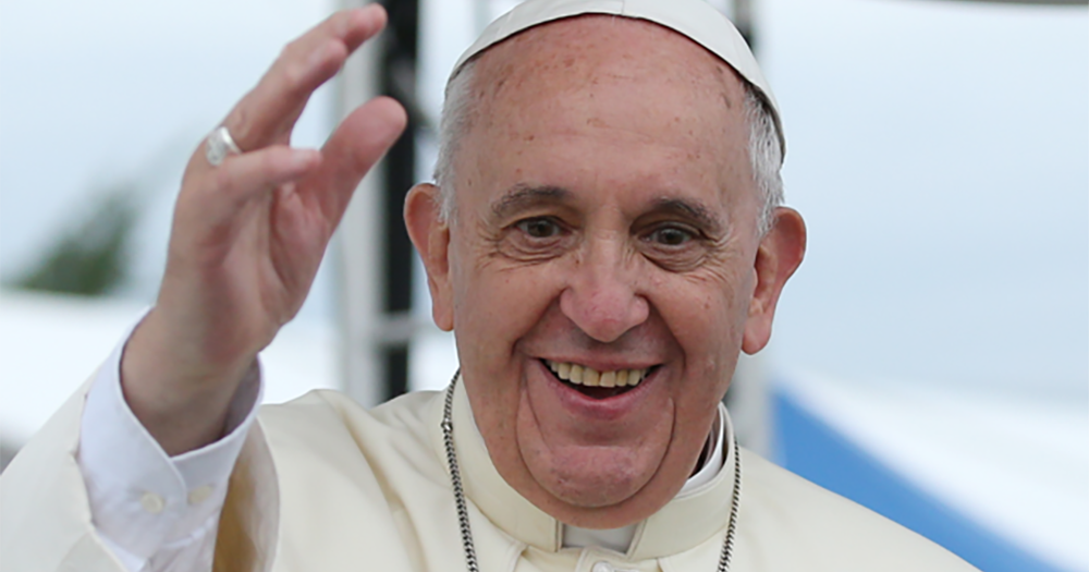 Pope Francis who has urged parents to support queer children smiles and waves.