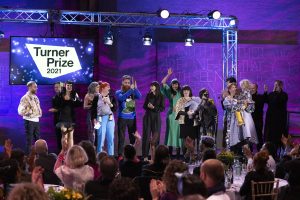 The 11 members of the Array Collective on stage at the Turner Prize Award ceremony receiving their award.