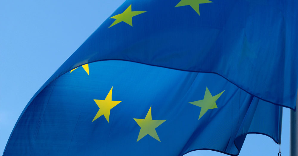Close up of EU flag: blue with yellow stars. This story details the Council of Europe condemning the UK for anti-Trans rhetoric.