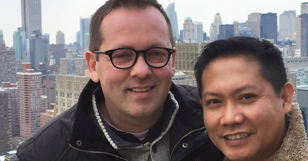 Image of LGBTQ+ activist Eoin Collins and his husband Josep pictured at the top of the Empire State building