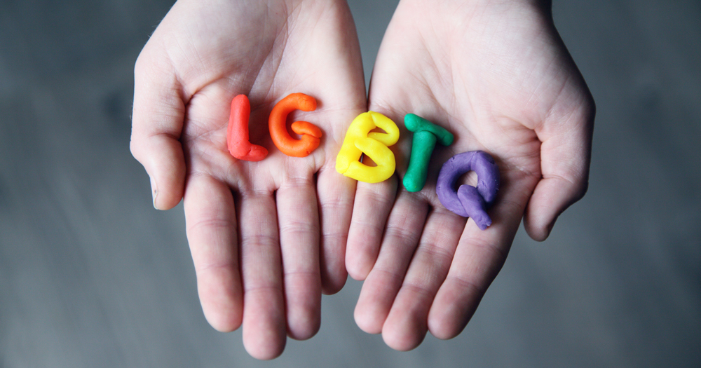 A pair of hands holding the letters LGBTQ made out of different coloured playdough. This story details the 'Don't Say Gay' bill being passed by the House of Representatives.