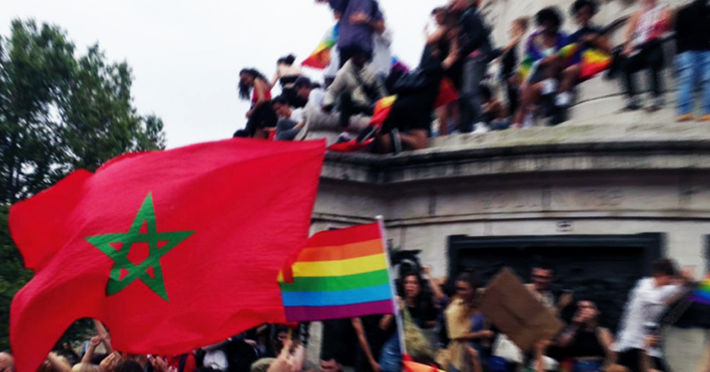 A portion of the poster for the conference Queer Maghreb Matters portraying people protesting with Moroccan and rainbow flags.